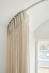Sheers in arched living room window